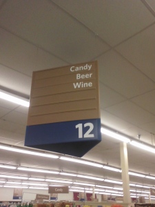 grocery store aisle sign reading "Candy, Beer, Wine"